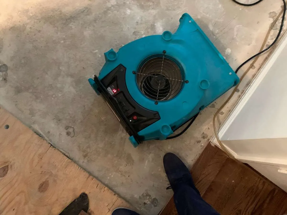 Air mover drying subfloor during Commercial Water Damage Restoration in Ontario